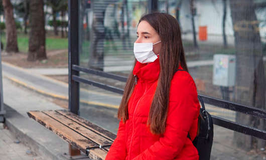 1689759630398474.jpg woman-wearing-surgical-mask-bus-stop.jpg